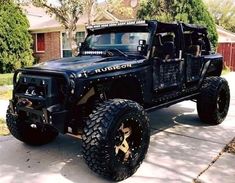 a black jeep is parked in front of a house