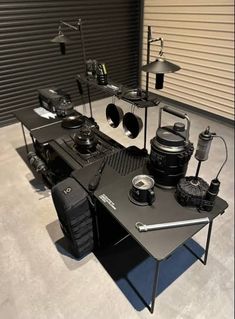 a black table topped with lots of different types of musical equipment on top of it