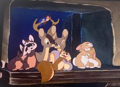 several animated animals sitting on top of a shelf