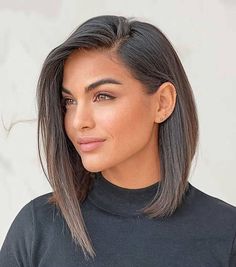 Woman with an uneven long bob and deep side part, offering length and definition for round faces. Bob Hairstyles For Round Face, Deep Side Part