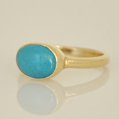 "This is a perfect gift for her. A fine gold and Turquoise ring. Beautiful Turquoise stone set in high gold bezel. The ring is 14k yellow gold, with oval bezel. The Turquoise cabochon gemstone is a beautiful, blue, shining stone that contrasts with the yellow of the gold. This ring can be a romantic gift, or a gift for a daughter, mother, wife or anyone you love. Picture #1 ,#4 and #8 are with a similar Turquoise gold ring but different color Turquoise . Dimensions: * The ring's width is 2 m\"m Yellow Gold Turquoise Ring With Polished Finish, Elegant Gold Turquoise Ring With Bezel Setting, Fine Jewelry Turquoise Ring In Yellow Gold As Gift, 14k Gold Turquoise Oval Cabochon Ring Gift, Fine Jewelry Turquoise Ring In Yellow Gold, Fine Jewelry Hallmarked Turquoise Ring In Yellow Gold, Fine Jewelry Hallmarked Yellow Gold Turquoise Ring, Elegant 14k Gold Hallmarked Turquoise Ring, 14k Yellow Gold Hallmarked Turquoise Ring