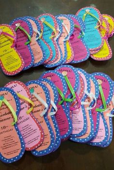 a bunch of flip flops that are sitting on a table with ribbons around them