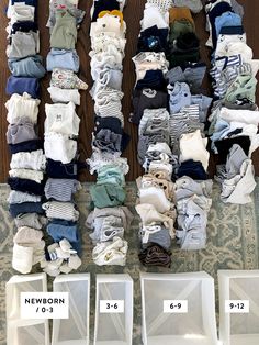 a pile of clothes sitting on top of a wooden floor next to white plastic chairs