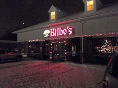 the front of bill's restaurant lit up at night with christmas lights on it