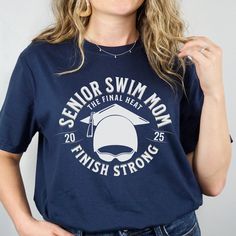 a woman wearing a sailor swim mom t - shirt with the words finish strong on it