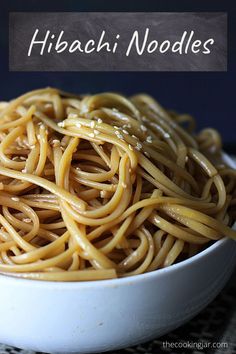 a white bowl filled with noodles on top of a table