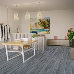 an empty clothing store with clothes hanging on the rack and two tables in front of them