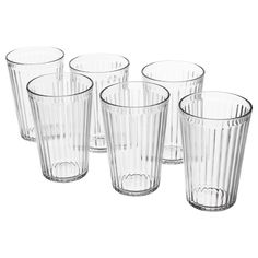 six clear glasses are lined up in a row