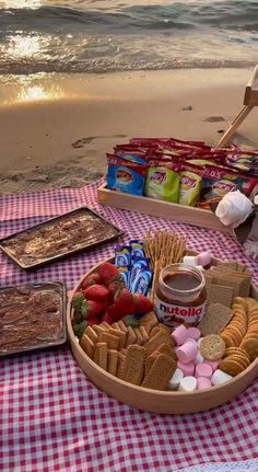 a picnic on the beach with food and snacks