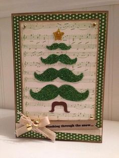 a card with a christmas tree made out of mustaches