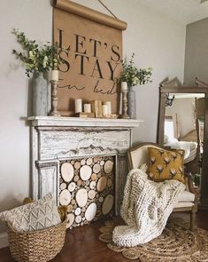 a living room filled with furniture and a fire place covered in a sign that says let's stay