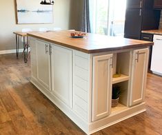 a large kitchen island with an open shelf