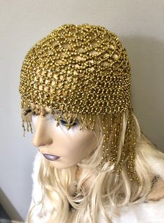 "Sassy headdress hat with all over shiny beads and fringe in front and back. Beads hang 4\"-6\" in the back and 1\" front with Stretch to fit around entire head. Color: Gold" Fitted Gold Costume Hat For Carnival, Elegant Rhinestone Fringe Headpiece For Party, Elegant Party Headpiece With Rhinestone Fringe, Adjustable Gold Costume Accessories For Festivals, Fitted Gold Carnival Costume Hat, Glamorous Adjustable Rhinestone Headpieces, Glamorous Adjustable Party Headpieces, Bohemian Gold Headpiece For Party, Gold Fitted Festival Headpiece