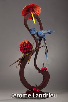 a sculpture with birds and flowers on it