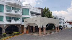 an apartment building with balconies on the second floor