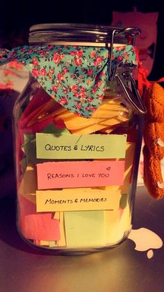 a jar filled with lots of notes on top of a table