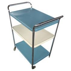 a blue and white cart with two shelves on it's sides, sitting upright