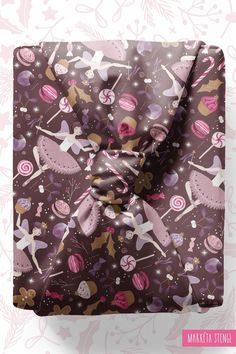 the wrapping paper is wrapped in brown and pink fabric with ballet themed designs on it