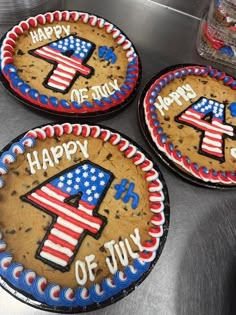 three decorated cookies with the number four on them