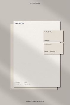 two white envelopes on top of each other with the same letterhead and address card