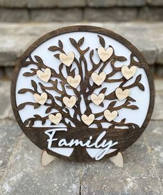 a wooden family tree with hearts on it