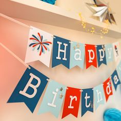 a happy birthday banner is hanging on the wall