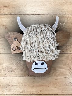 an animal made out of yarn with the word welcome on it's face and horns