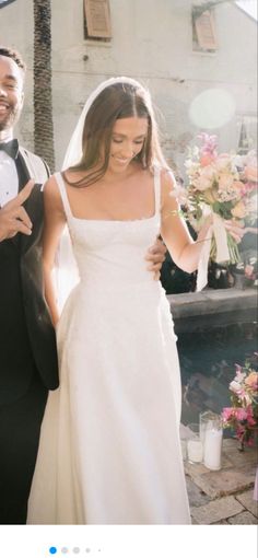 a bride and groom walking down the aisle