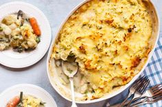 a casserole dish with broccoli, potatoes and carrots on the side