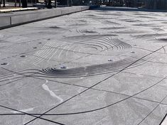 an artisticly designed concrete walkway in front of a building