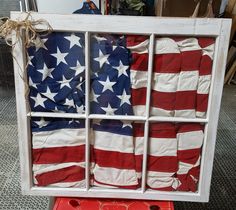 an american flag is displayed in a window