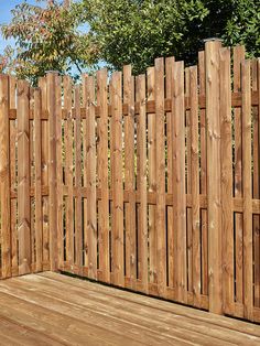 a wooden fence next to a wood deck