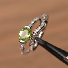 It is a natural peridot ring. The main stone is 6 mm*8 mm oval cut.weight about 1.33 carats.The basic metal is sterling silver and plated with rhodium.To change the metal to a solid gold (white/rose) or platinum is also available, please ask for a quotation if you want.You can also go to my shop Home for more elegant rings: https://www.etsy.com/shop/godjewelry?ref=hdr_shop_menuPeridot is August birthstone More peridot rings:https://www.etsy.com/shop/godjewelry?ref=seller-platform-mcnav&secti Oval Peridot Ring In White Gold, Oval Peridot Birthstone Ring For May, Oval Peridot Birthstone Ring In Fine Jewelry, Peridot Oval Birthstone Promise Ring, Oval Peridot Birthstone Promise Ring, Oval Peridot Birthstone Ring, Peridot Rings, Elegant Rings, August Birthstone Ring