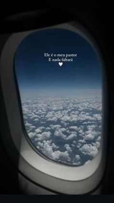 an airplane window looking out at the clouds and sky with a quote written on it