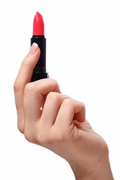 a woman's hand holding a red lipstick