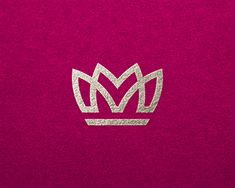 a pink towel with a silver crown on it's front and bottom corner,