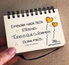 a hand holding a spiral notebook with writing on the front and back cover that says emoba naca sea, eterno, tudo que cumas da que cumos do dar mais