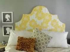 a bed with yellow and white pillows on it's headboard in a bedroom