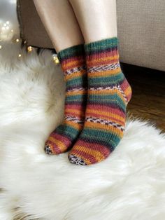 Step into the warm embrace of autumn with our Cozy Harvest Stripe Hand-Knit Socks. These stunning socks are crafted from a luxurious blend of 88% cotton and 12% nylon, offering a perfect balance of softness and durability. The intricate pattern of vibrant stripes captures the rich hues of fall, including deep burgundy, forest green, burnt orange, and golden yellow, making them a stylish addition to your wardrobe. Inspired by the cozy charm of fall, these socks are perfect for those chilly mornin Cozy Green Socks For Winter, Cozy Multicolor Socks For Gifts, Cozy Multicolor Socks For Gift, Cozy Multicolor Socks As Gift, Cozy Winter Socks With Fair Isle Pattern, Cozy Knitted Socks For Fall, Cozy Hand Knitted Socks For Fall, Comfortable Knitted Socks For Fall, Cozy Warm Multicolor Socks