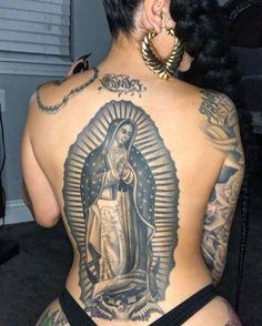 the back of a woman with tattoos on her body