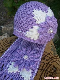 a crocheted hat with flowers on it