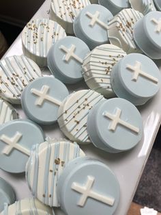 cupcakes decorated with white and blue icing on a table