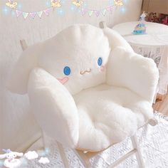 a white chair with a large stuffed animal on it's back and blue eyes