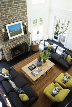 a living room filled with furniture and a fire place in the middle of the room