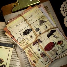 an open book sitting on top of a table next to other books and lace doily