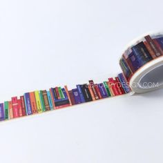 a roll of colorful bookshelves printed on a white background with the words library tape