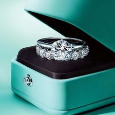 an advertisement for tiffany & co featuring two diamond rings