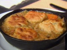 a skillet filled with food sitting on top of a stove