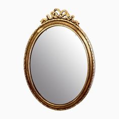 an ornate gold framed mirror on a white background, with the reflection in it's center