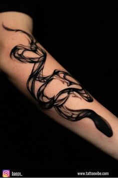 a black and white tattoo design on the arm